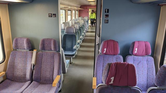 Interior of a class 628 with purple and blue as main colors.