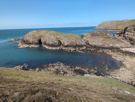 Sea cliffs, but unreal and turquoise sea with caves