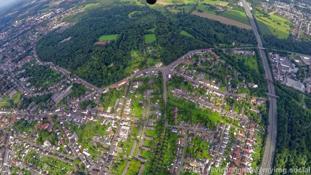 An aerial photo of herten near the border to recklinghausen. You can see multiple living quaters sourrounded by trees and parks. There are some alleys and a freeway.