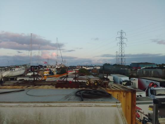 View out across the boatyard looking south, some pink in the clouds.