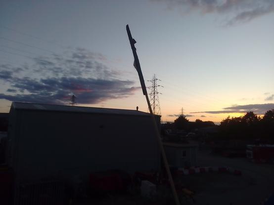 Pylons, an industrial shed and the setting sun in the west.