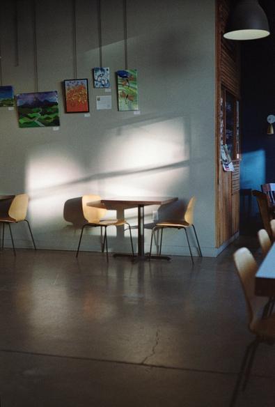 Two chairs and a table against a wall at a brewery.