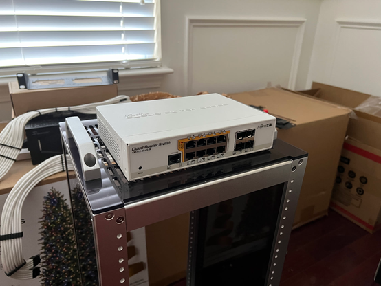 A Mikrotic PoE switch that should fit perfectly in the 10" rack that it sits on top of.