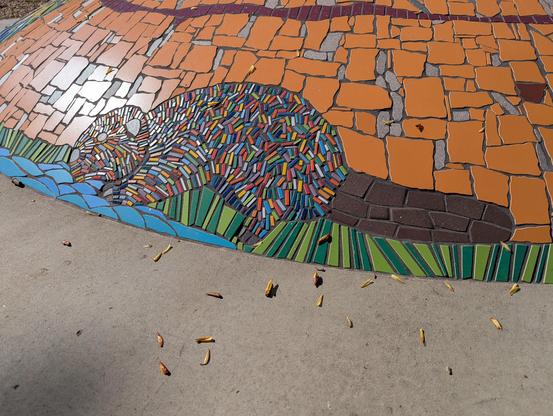 A close up detail on a mosaic beaver from the previous sculpture, mamohkamatowin (Helping Each Other) by Jerry Whitehead.
