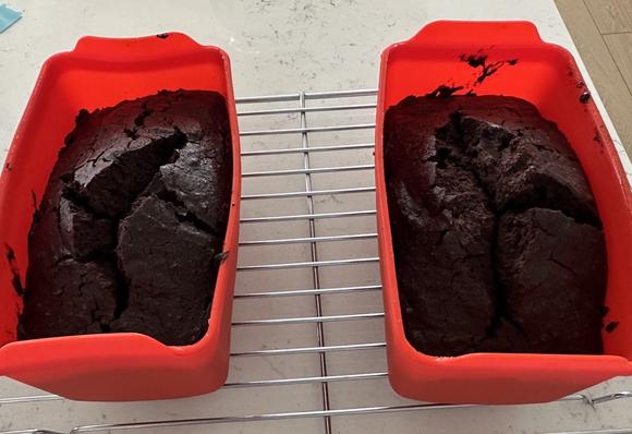 Two small loaf pans of brownies, fresh out of a solar oven
