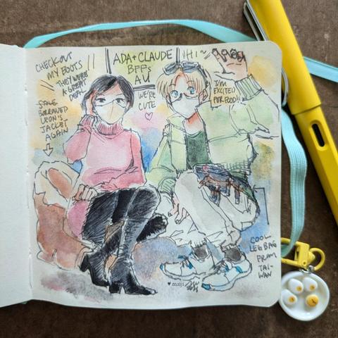 Photo of sketchbook with ink and watercolour drawing labelled "Ada+Claude BFFs AU". A small keychain of a plate with happy-faced fried eggs hanging off the book band and a yellow pen peek in from the edges. Ada Wong from Resident Evil and Claude C. Kenni from Star Ocean 2 are crouching/squatting together and greeting the viewer while wearing face masks and modern-day outfits reminiscent of their official designs with the words "We're cute (heart)" in between them. Ada is saying "Check out my boots, they were a great deal" and tucked behind her is Leon's jacket which she stole borrowed again. Claude is waviing and saying "Hi~ I'm excited for food!!" An arrow points to his waist and leg that reads "Cool leg bag from Taiwan".
