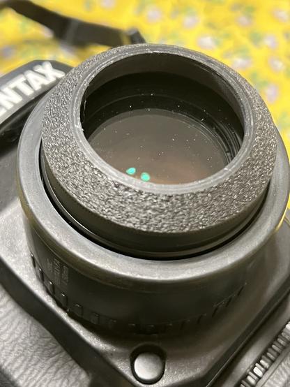 A 3d printed “low profile” hood on my Pentax 50mm lens.
