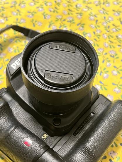 A rubber hood still provides access to the filter threads and the cap fits. As shown in this photo with the cap and hood.