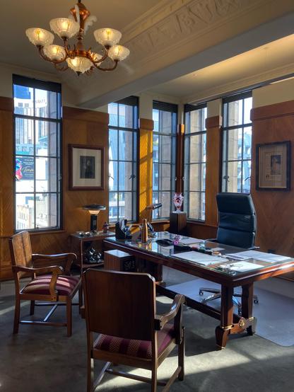 An art deco style office with lots of wood paneling and ornate furnishing