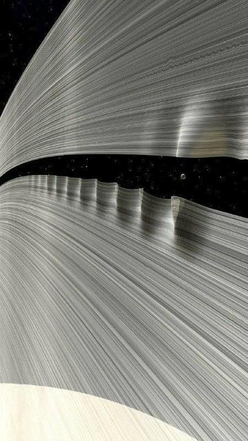 An image showing Daphnis and ripples in Saturn's rings