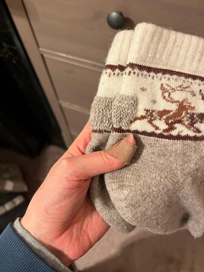 Shorty wool socks with reindeer on the ankles. Swiss darning in a neat rectangular block on the back of the heel where it rubs against my slippers.