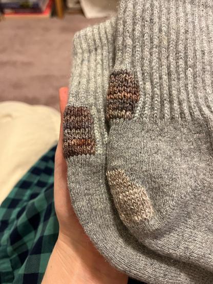 Grey wool socks (these are favorites and include yak down in the blend). A colorful Swiss darn in tidy rectangles on the backs of both heels, and a subtle more blobular Swiss darn on the bottom of one heel.