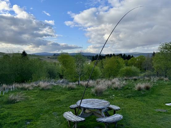 My wire antenna and tactical mast using a picnic bench for support. Surrounded by hills and trees.