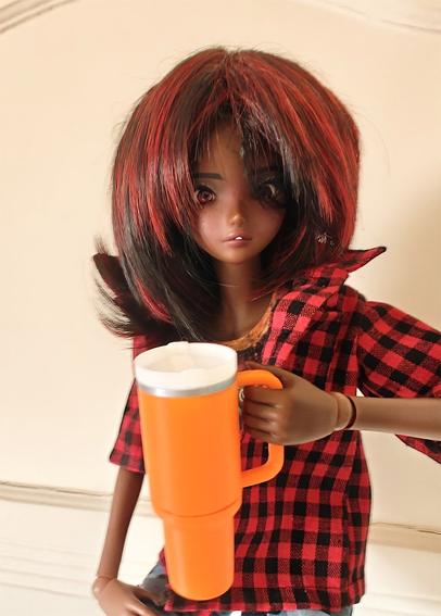 Cocoa Smart Doll with an orange Stanley Cup
