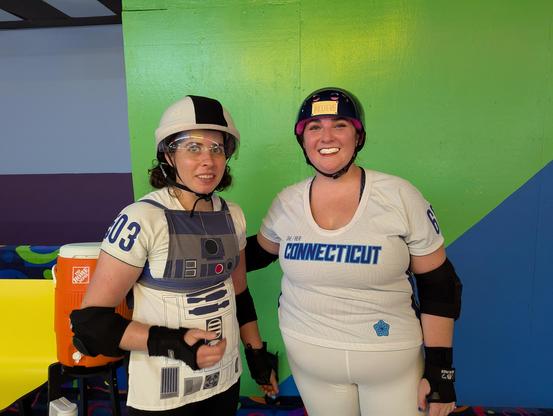Two roller derby players pose for the camera.