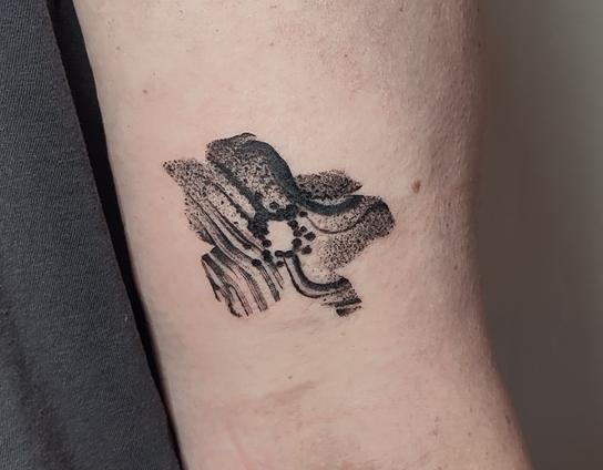 Flower tattoo on an upper arm