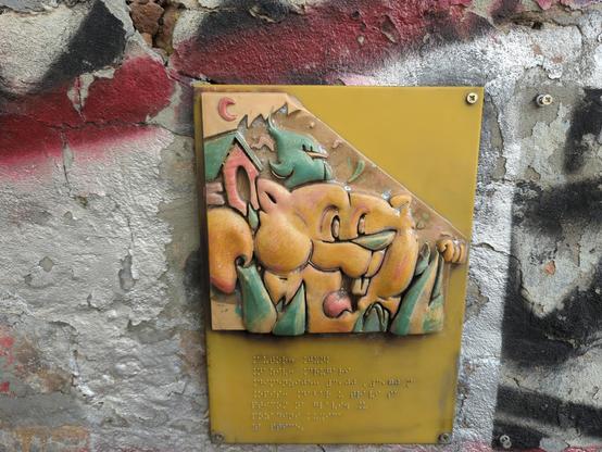 Small replica of cartoon on wall, with Braille beneath. It's 3D so you can feel it.