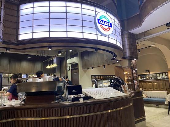A coffee shop interior featuring the "Coffee Oasis" logo.