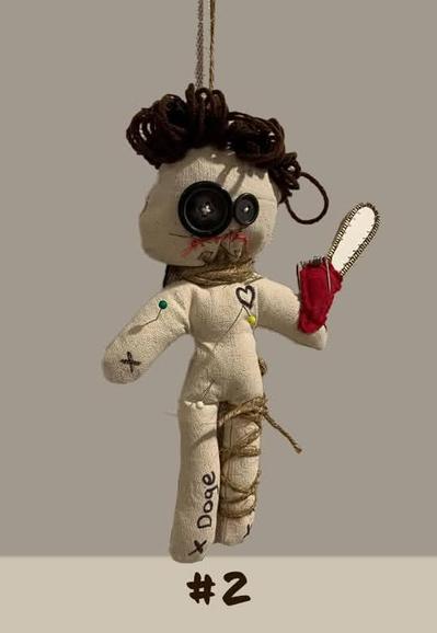 Vudon doll of Elon Musk with DOGE written on the leg and holding a chainsaw.