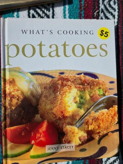 A cook book with a title "What's Cooking, potatoes"