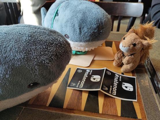 A small cuddly squirrel and two Smolhaj cuddly sharks sitting on a backgammon table. In between them are two #natenom memorial stickers.

Big cuddle for you, plushies!