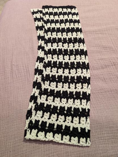 finished cat scarf on a lavender bedspread