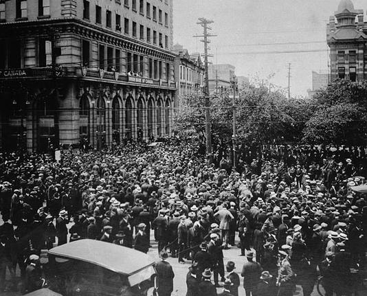Crowd gathered outside old City Hall, at Main Street and William Avenue, during the Winnipeg General Strike. Visible on the left are the Union Bank of Canada building and Leland Hotel.