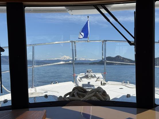 View through the windscreen of a boat with snow covered Mount Baker off of the distance.
This photo copyright 2025 by Maria Langer. All rights reserved. Neither this image nor the accompanying alt text may be used to train AI systems.