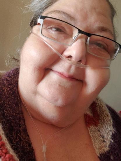 Me an Anglo woman with hair pulled back, glasses on, canula on face