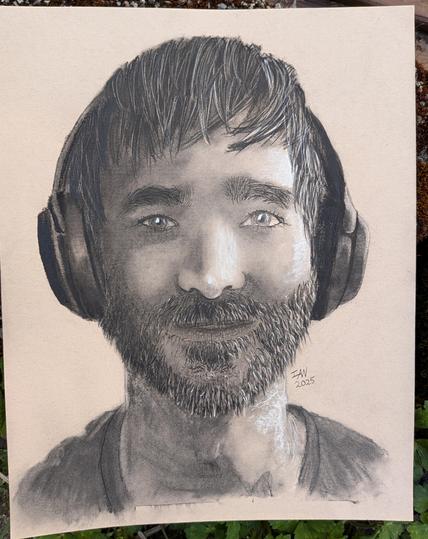 A charcoal drawing of a male's face with a short beard and large headphones
