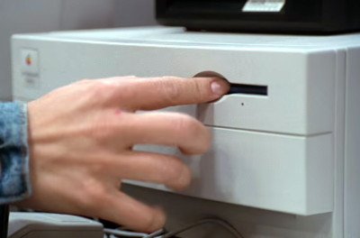 Angela uses a Power Mac 7100 at a trade show to email evidence to the FBI and to shutdown the Praetorian's systems with a virus.