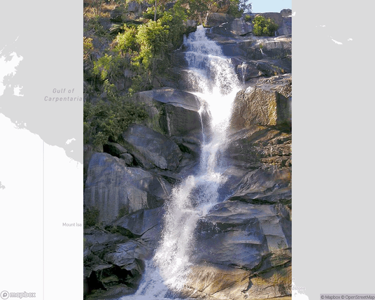 A photo of or from a national park from the linked website, overlaid on a cropped world map where it's located.