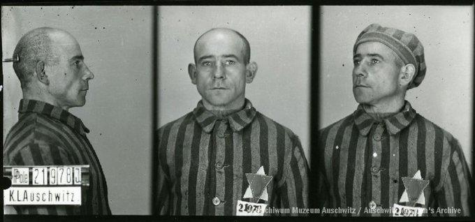 A mugshot registration photograph from Auschwitz. A man with a shaved head wearing a striped uniform photographed in three positions (profile and front with bare head and a photo with a slightly turned head with a hat on). The prisoner number is visible on a marking board on the left.