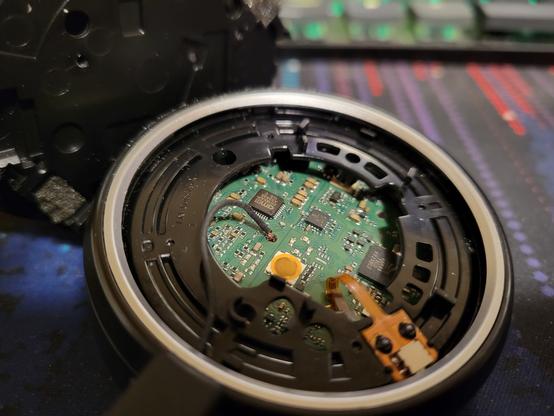 A Jabra Evolve 65 (1st edition) with the outer cover off showing the microphone cable's exposed wires near the PCB where the protective casing got shredded over time.
