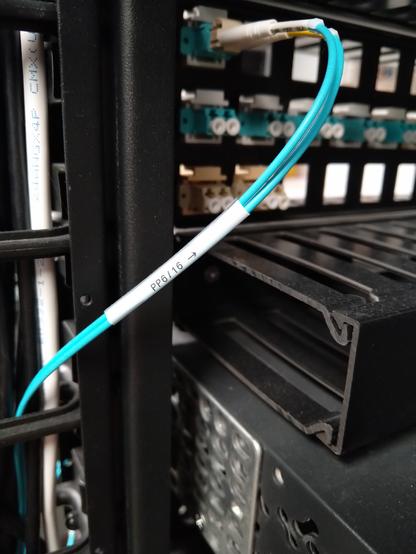 Blue fiber optic cable with self laminated wraparound label on it
