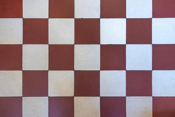 Alternating red and white tiles composing the kitchen floor in the Art Deco style Hôtel Danckaert in Brussels.