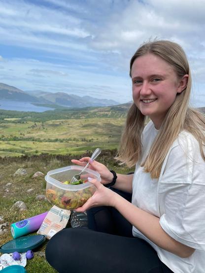 Leigh enjoying a picnic in the Scottish highlands. It is very green