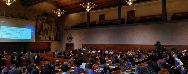 A panoramic view of the town hall at todays conference, with a panel of experts being questioned by the audience.
