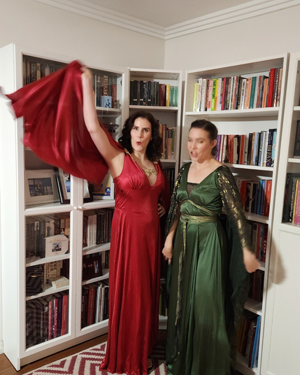 Image two: Dr Rad swishing her red dress dramatically while Dr G pulls yet another terrible face