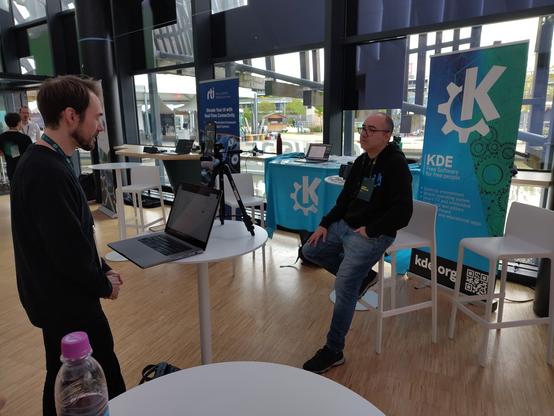 Albert sitting and being interviewed.