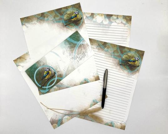 Product photograph of a stack of paper stationery sheets featuring an illustrated Blue Tit with brown and teal textures and a circular motif.