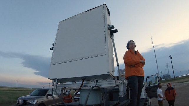 Prof. Tanamachi in the field with UMass Skyler mobile phased array radar in 2019. Frame grab from a Raytheon promotional film.
