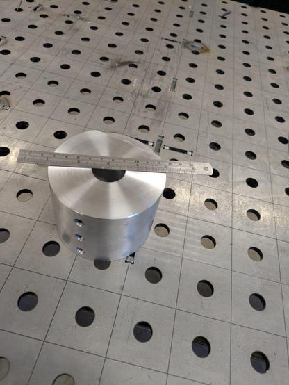The finished pulley with a ruler showing its size.