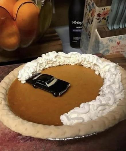 A pie bottom with whipcream about three quarter way around with a car in the middle. Making it seems the car does a fast&furious movie car donut thingy