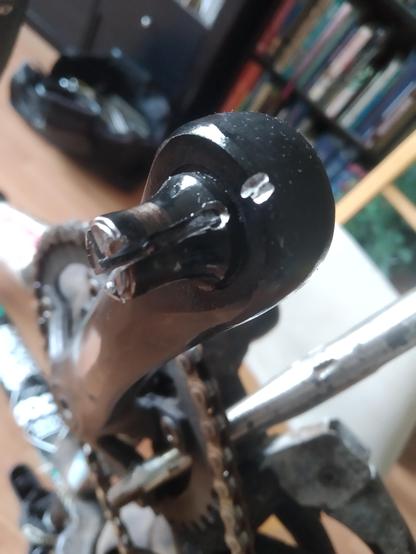 A bicycle crank with a broken axle nub sticking out.