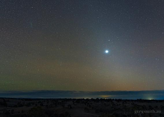 A view of the night sky including some green airglow, Venus, and two tiny meteor streaks as part of the Eta Aquariids shower.