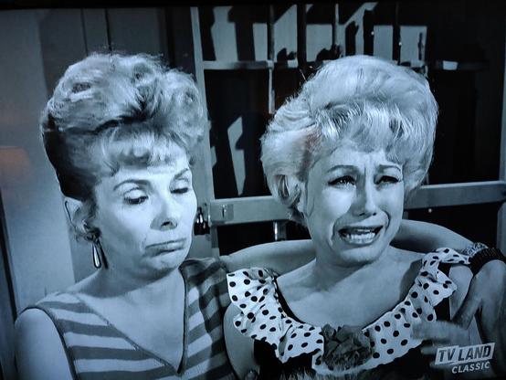 The two girls making faces on the TV