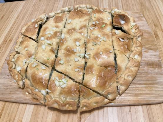 A circular spinach-filled flat pie.