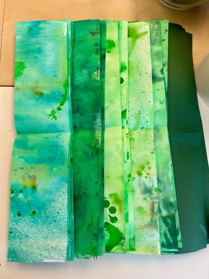 A pile of green papers cut into strips.