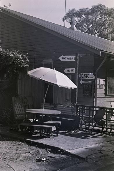 A small circular bit of outdoors seating for a community cafe in the Addison Road Community Centre in Sydney's Inner West. B&W photo.